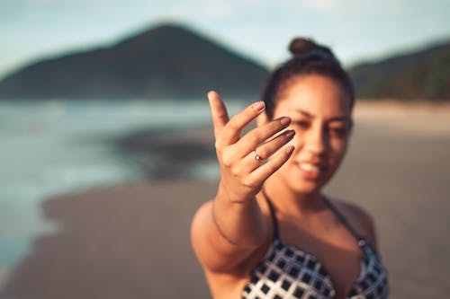 Free Woman Showing Her Right Hand at the Beach Stock Photo