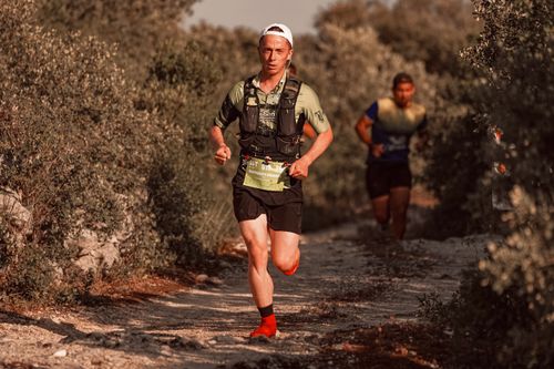 Free Two men trail running on a rugged rural path, engaged in a competitive race. Stock Photo