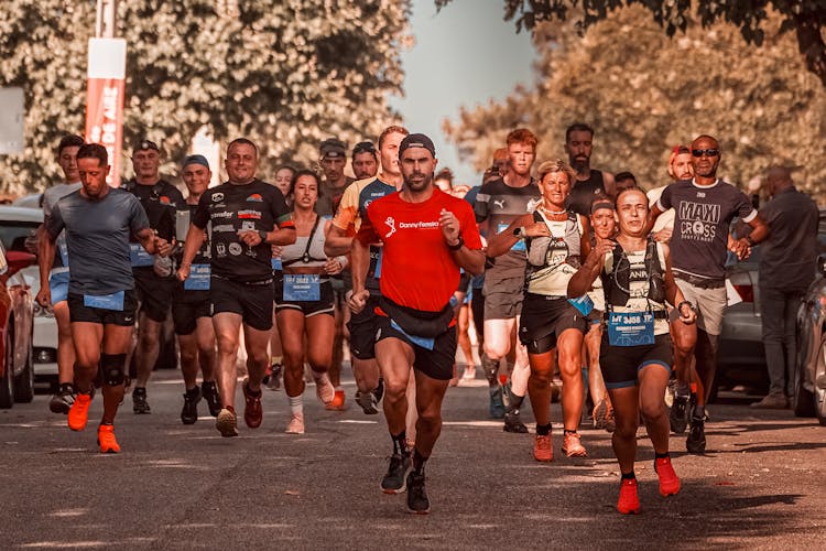 Group Of Athletes Running On A Street At A Marathon Race