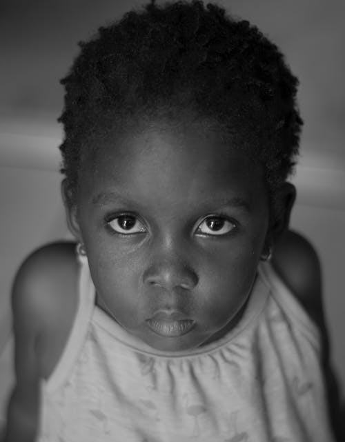 Black and White Portrait of a Little Girl with Short Curly Hair