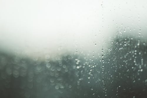 Free Blurred Photo of Window Glass Covered with Water Drops Stock Photo