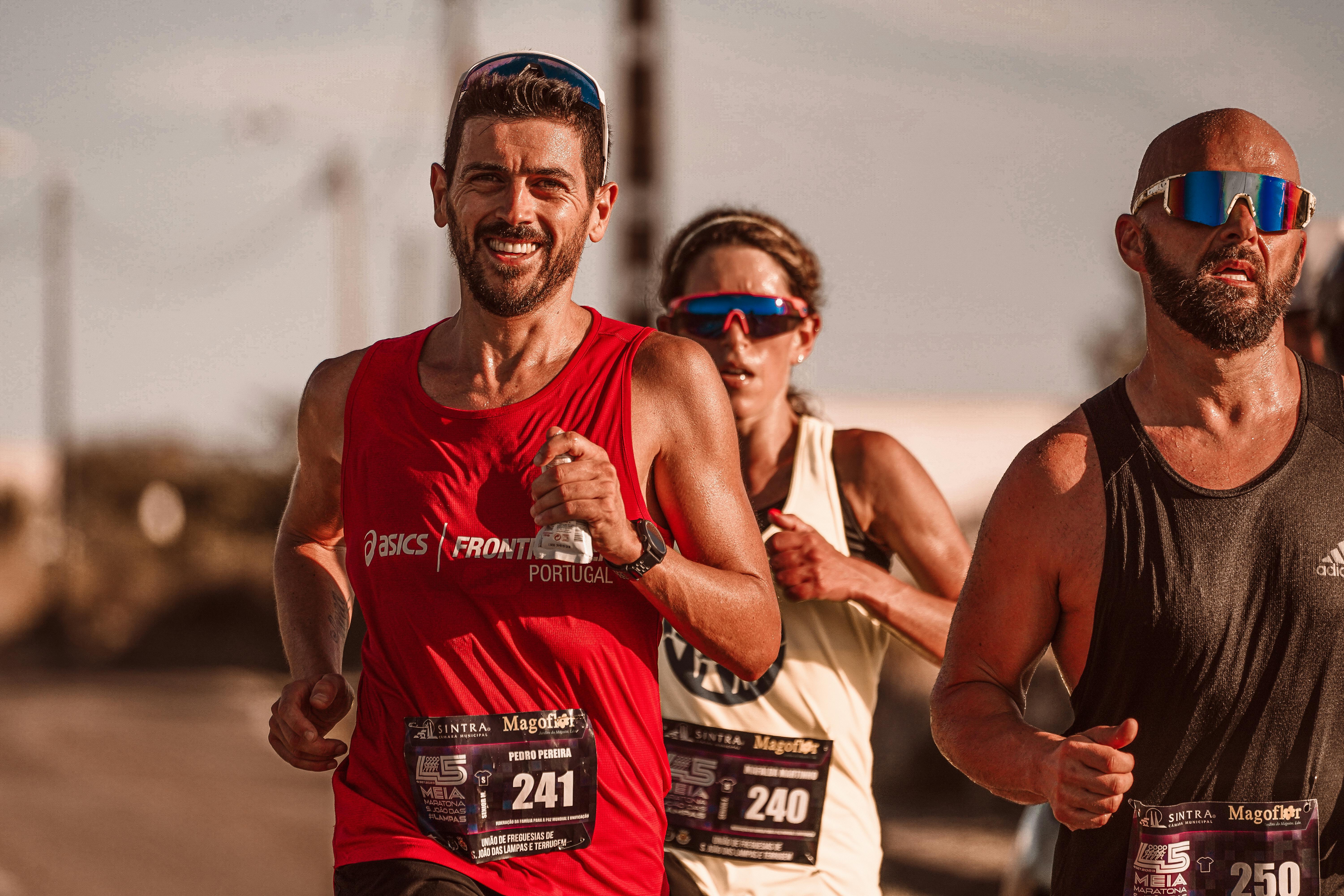 Runners displaying determination and strength as they compete in a marathon outdoors.