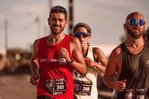 Free Runners displaying determination and strength as they compete in a marathon outdoors. Stock Photo