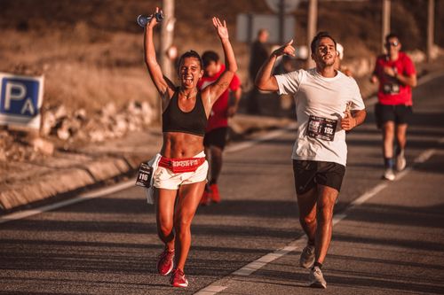Free Happy athletes running and celebrating during a sunny marathon race. Stock Photo