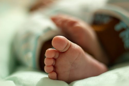 Free Foot of Baby Lying Down Stock Photo