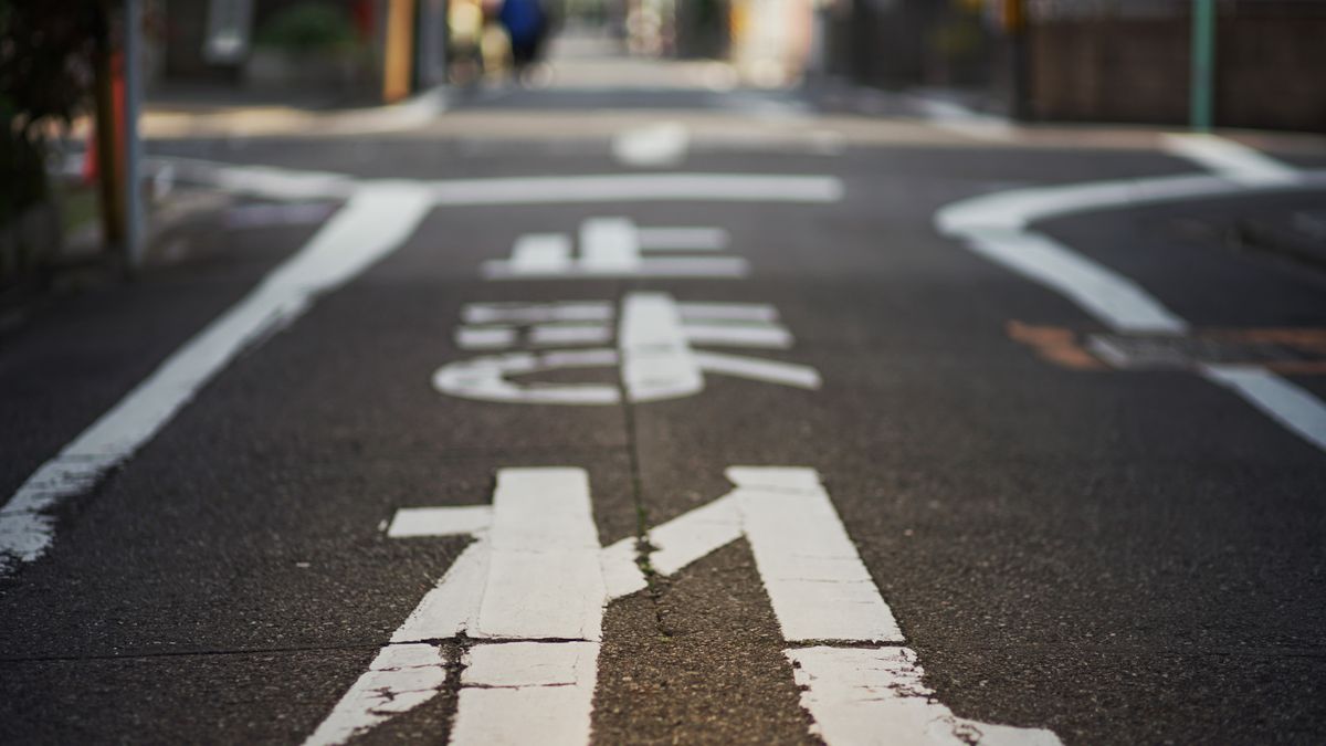 日本の市街地の道路。路面に白い文字と線が引かれている