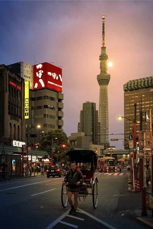 Man with Rickshaw on Street of Tokyo with Tokyo Skytree behind