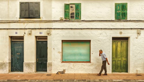 Elderly Man Walking on Sidewalk