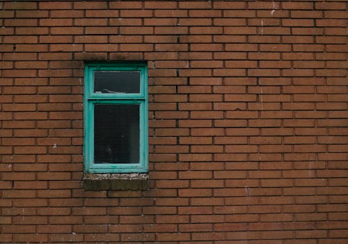 Damaged Window on Building Wall