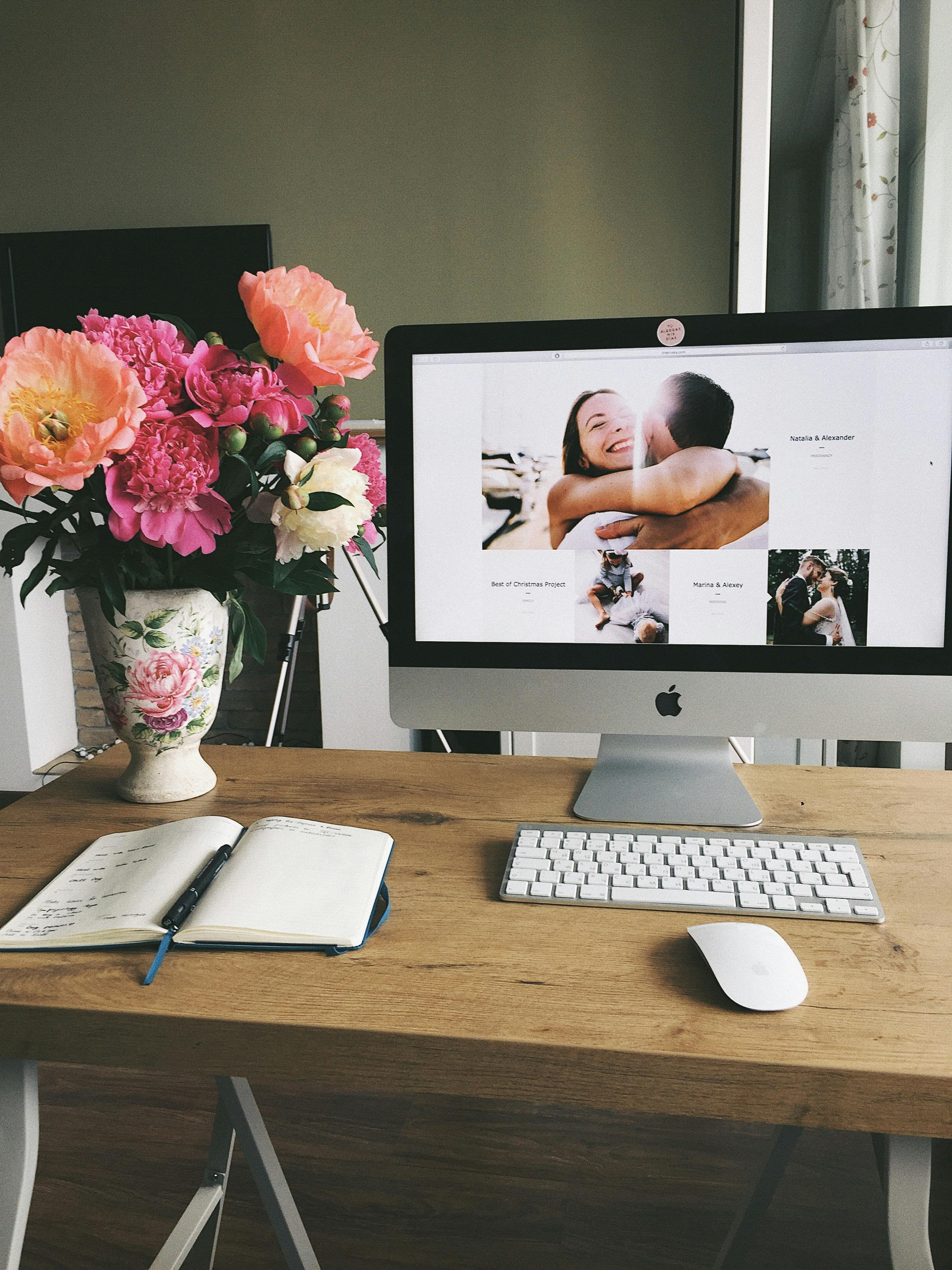 turned on silver imac displaying woman hugging man