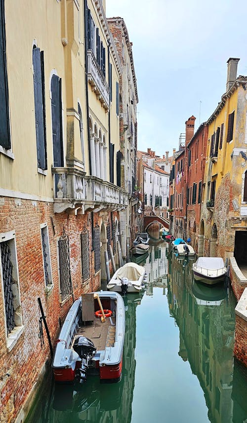 Boats in the Canal between Buildings in Venice, Italy