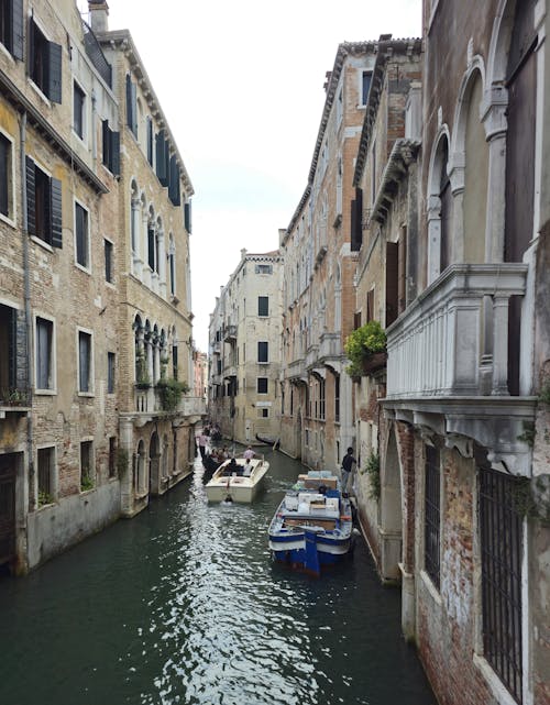 Boats in the Canal between Buildings in Venice, Italy