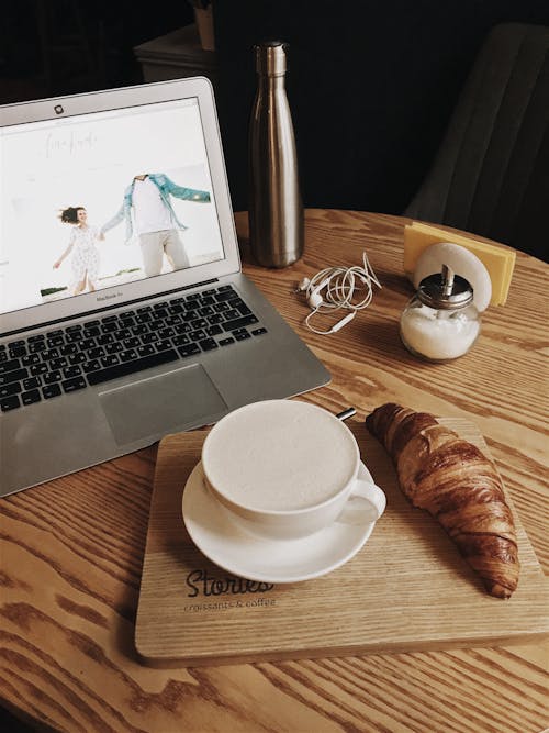 Free Macbook Pro Beside Teacup Stock Photo