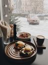 Hamburger on Round Brown Ceramic Bowl Beside Mug Filled With Coffee
