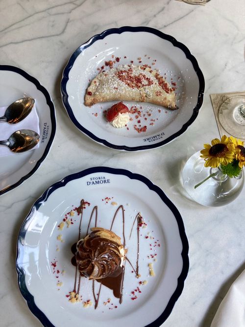 Free Beautifully presented desserts with chocolate and strawberry garnishes on elegant plates. Stock Photo