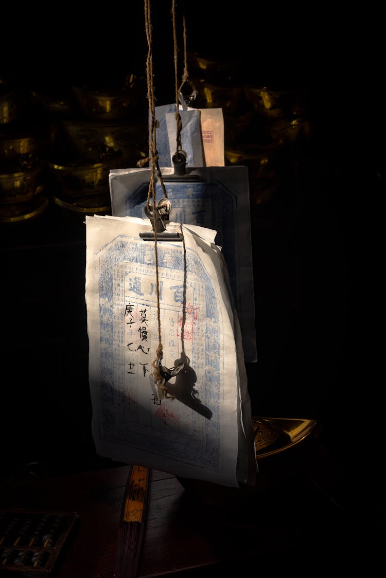 Papers With Chinese Writing Hanging On Lines