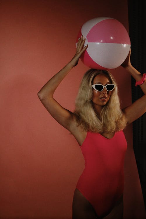 Blonde Woman in Sunglasses Standing with Ball