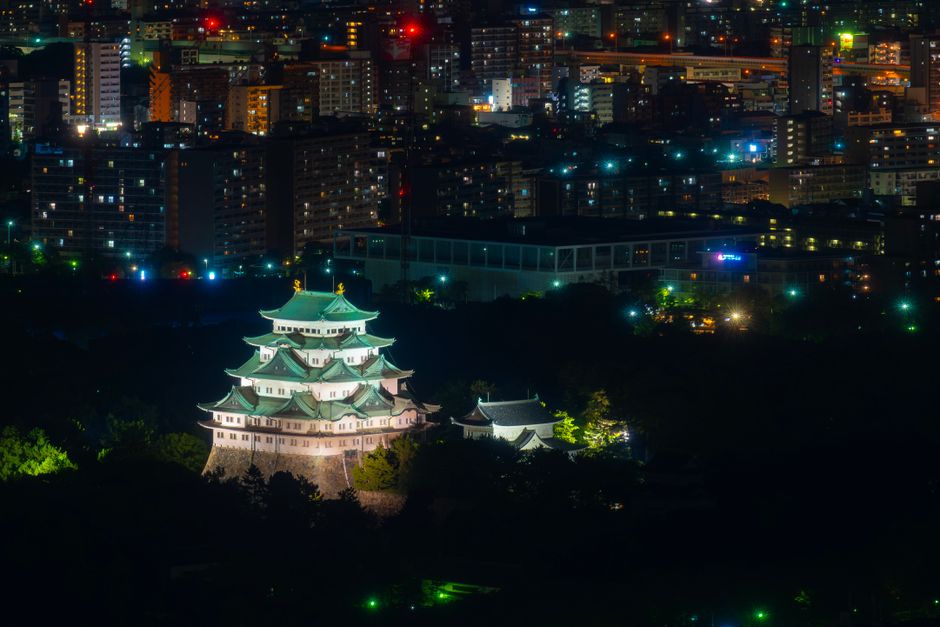 Nagoya Castle glowing amidst the city lights of Nagoya, Japan, captured at night.