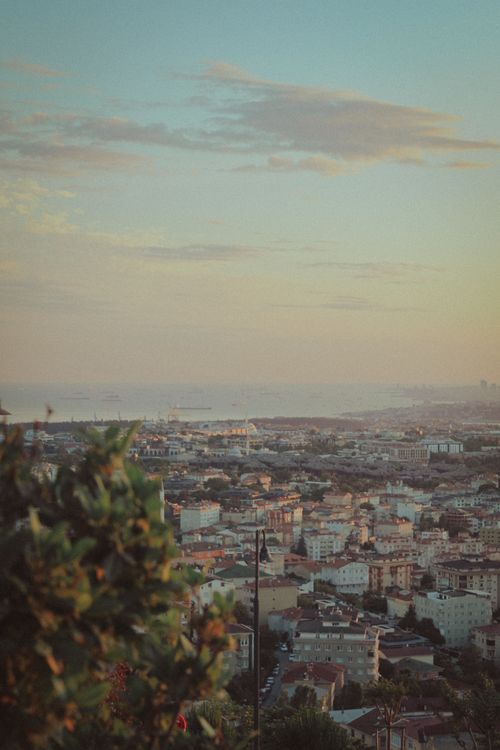 Free A picturesque cityscape with seafront views under a warm sunset sky. Stock Photo