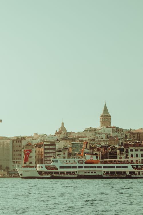 Free A picturesque view of Galata Tower with a ferry on the Bosphorus in Istanbul, Turkey. Stock Photo
