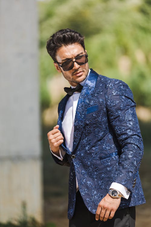 Model in a Navy Blue Tuxedo with Embroidered Floral Patterns