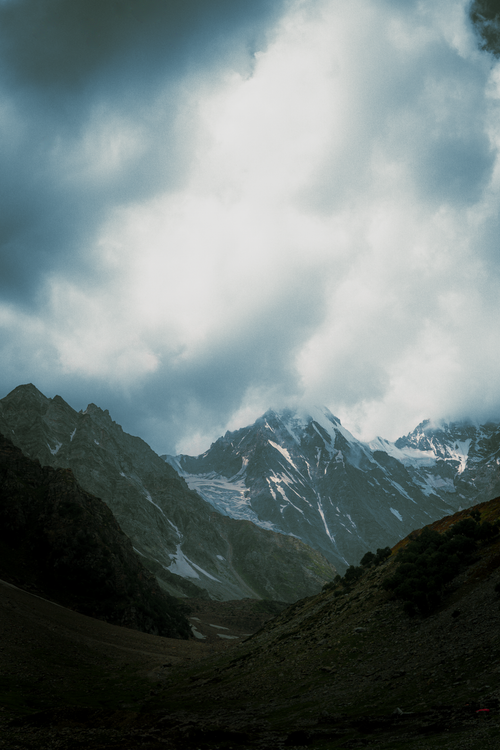 Free Breathtaking snowy peaks of the rugged Himalayas beneath a dramatic cloudy sky. Stock Photo