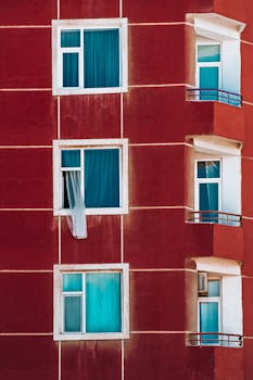 A vibrant red facade with blue windows, capturing modern urban architecture in Baku.