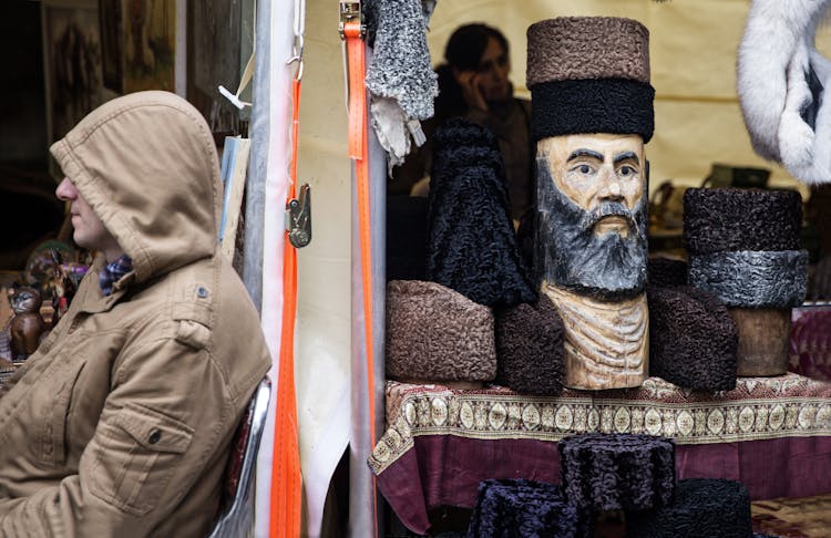 Vendors On Market Stalls With Souvenirs And Karakul Hats