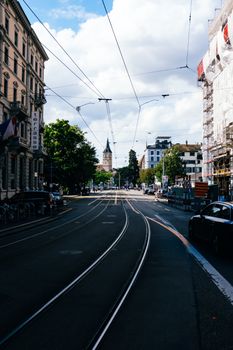 A city street with tram tracks and historic architecture, perfect for urban themes.