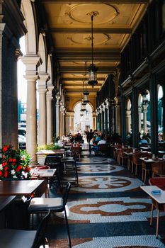 Luxurious restaurant dining in a beautiful Zurich colonnade with stylish decor.