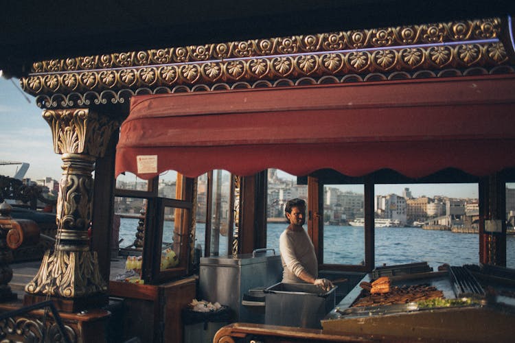 Man Standing In Front Of Grill