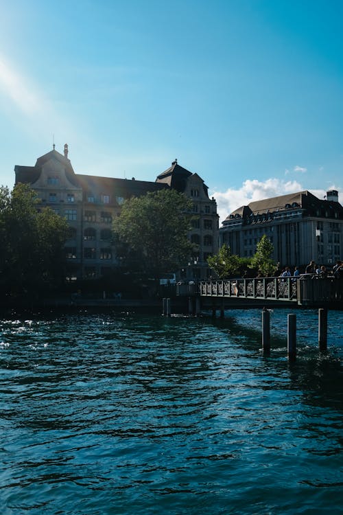 People Walking on a Bridge over Limmat River in Zürich, Switzerland