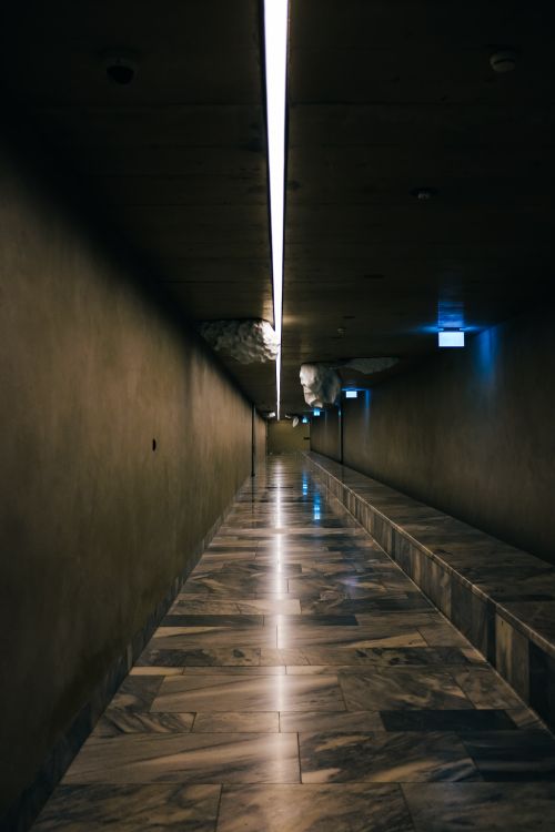Free Explore a contemporary hallway with marble flooring and sleek LED lighting. Stock Photo