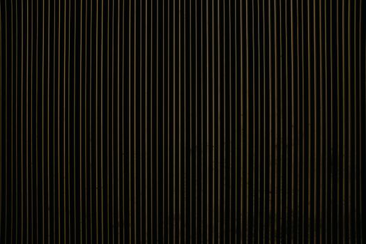Close-up of vertical striped pattern with dark tones for design or texture use.