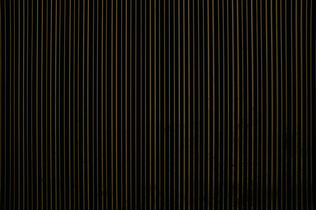 close up of vertical striped pattern with dark tones for design or tex