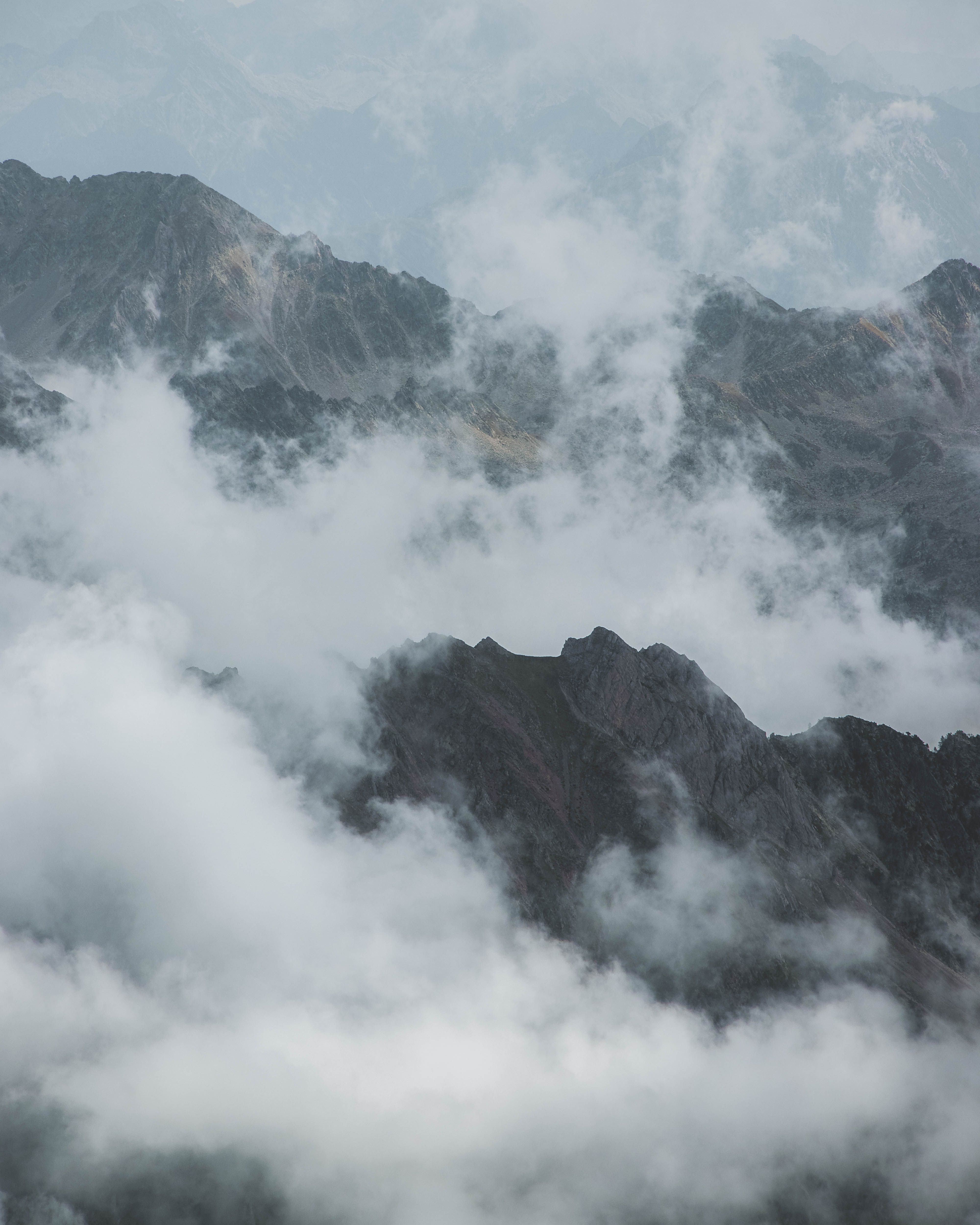 Aerial View of Rocky Mountain Peaks in Clouds · Free Stock Photo