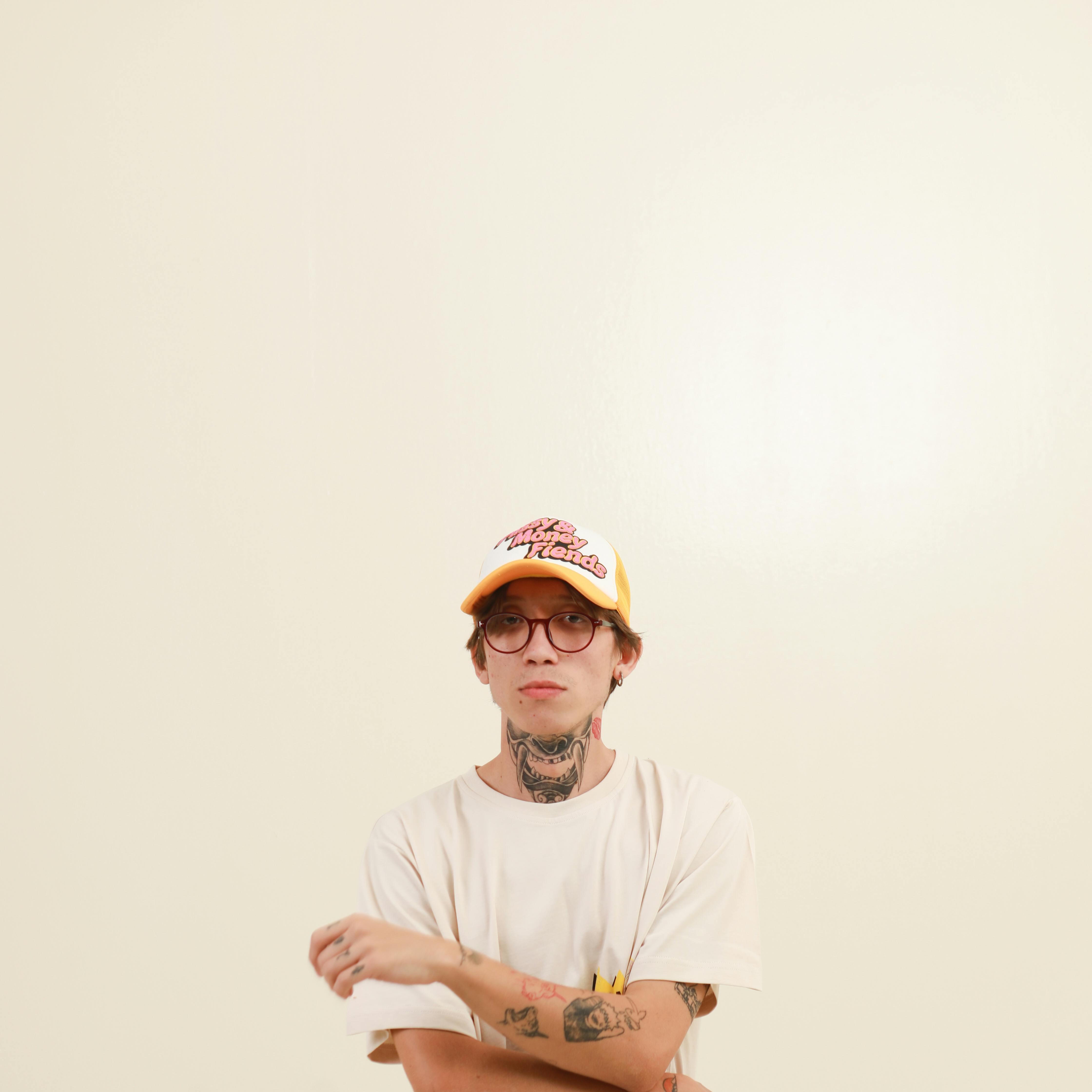 Young Man with Tattoos Wearing a Cap