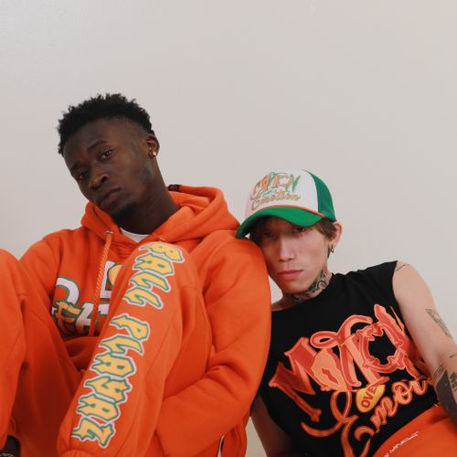 Free Dynamic studio shot featuring two men in colorful streetwear, exuding modern style. Stock Photo