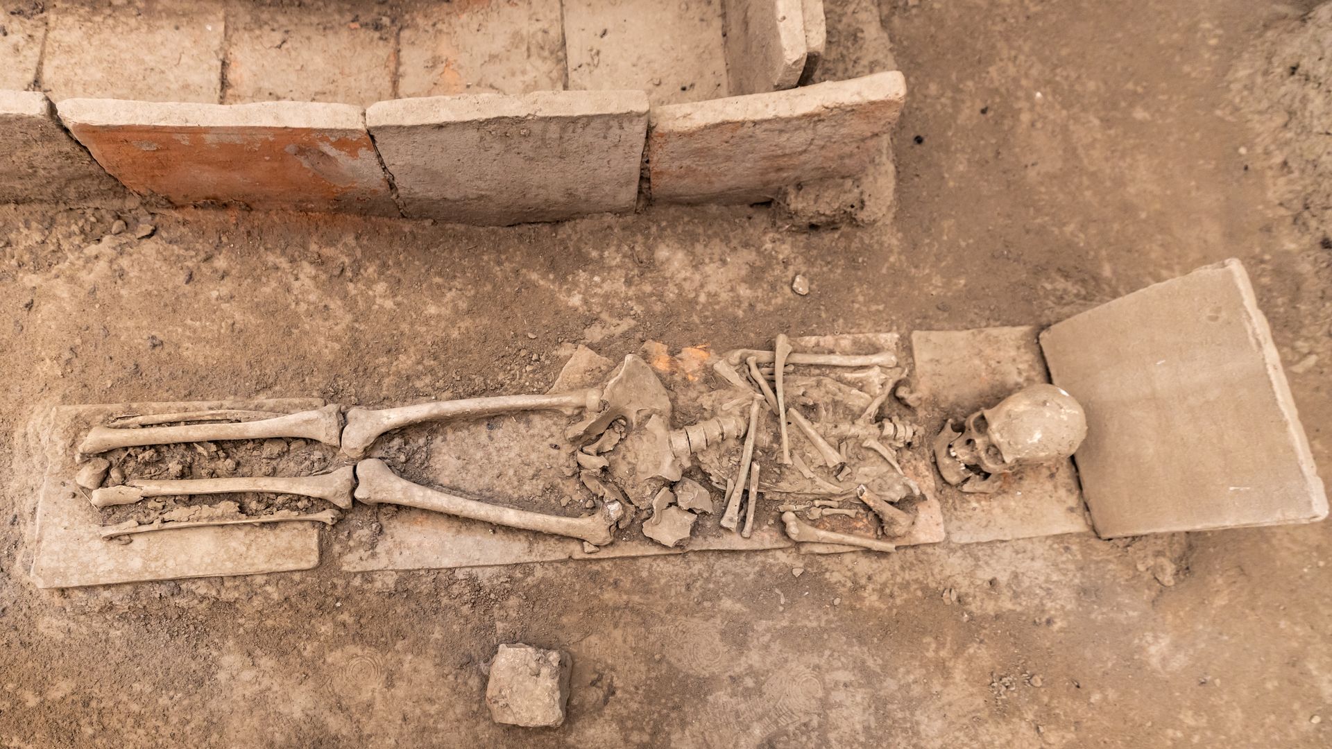 An archaeological excavation site with ancient burial remains
