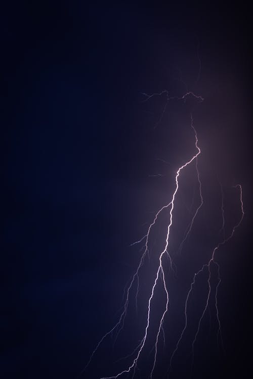 Lightning in the sky over a dark blue background
