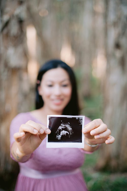 Ultrasound Photo Held by a Happy Future Mother