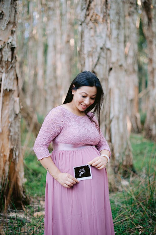Portrait of Pregnant Woman Wearing Pink Dress