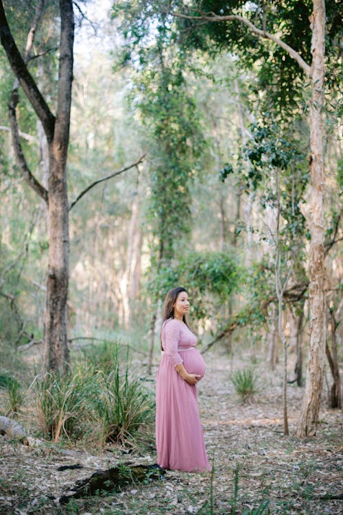 Pregnant Woman on a Walk in the Forest