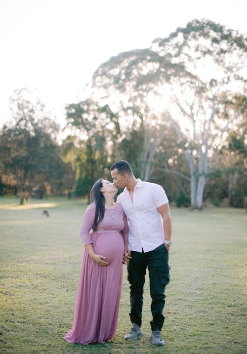 Kissing Couple Happy About Pregnancy