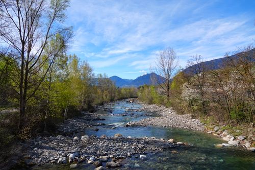 Free A picturesque view of a serene river flowing through Riffian, Trentino-Südtirol, Italy. Stock Photo