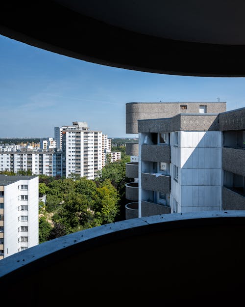 The view from the window of a building shows a city