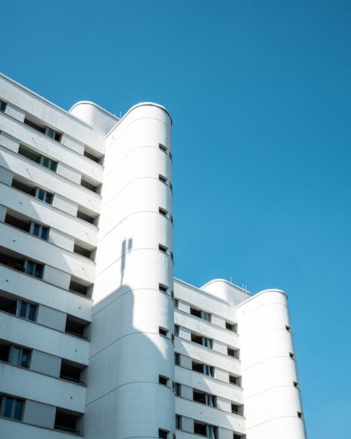 A tall building with windows and a blue sky