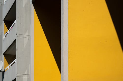 A yellow building with a shadow on it