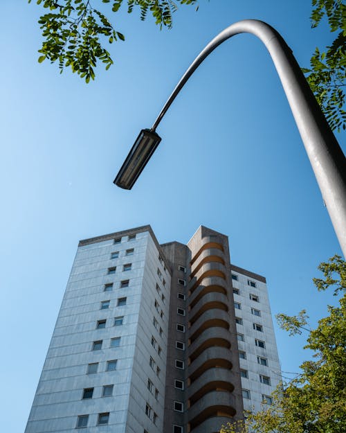 A street light is next to a tall building