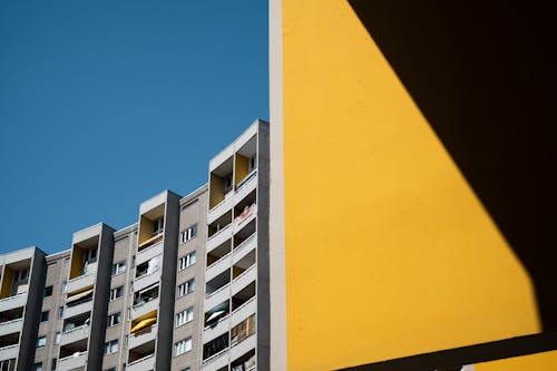 A yellow building with a blue sky in the background
